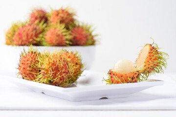 Ripe rambutan fruit on plate with white background, Tropical fruit