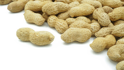 Heap of dried peanuts, Monkey nuts, Groundnuts, Isolated on white background, Close up