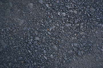 Granite gravel of macadam floor, Rock gray crushed for construction on the ground, Scree texture background