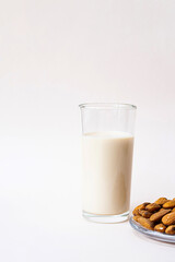 Almond milk with almond on the light background with copy space. Dairy free and lactose free nut milk, healthy eating, vegan and diet concept.