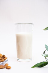 Almond milk with almond on the light background with copy space. Dairy free and lactose free nut milk, healthy eating, vegan and diet concept.