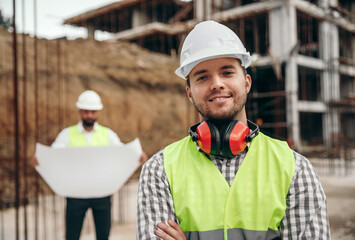 Smiling male builder at construction site