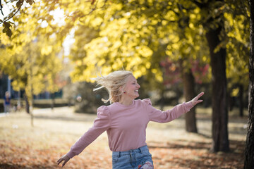  Happy young woman enjoying in the park.