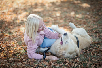  Woman playing in park with her dog.