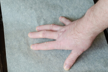 Step by step preparation of homemade beer snacks. Hand roll a roll of parchment onto a baking tray.