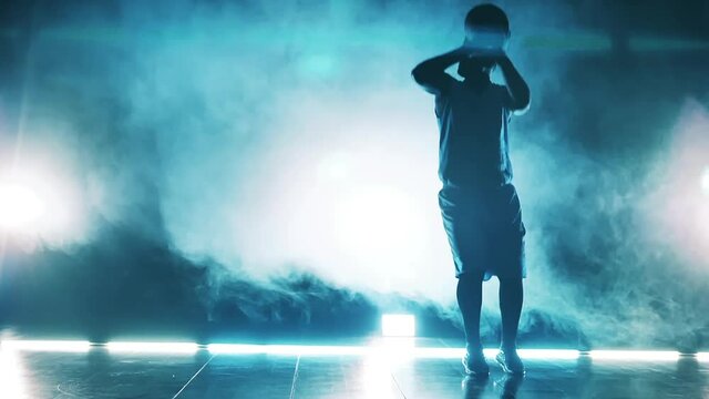 Male athlete is practicing basketball moves in slow motion