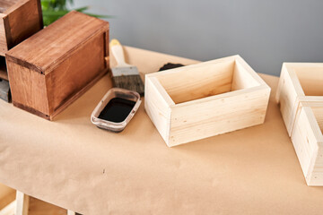 A set of blanks of wooden boxes for flower compositions. Small business woodwork workshop. In your work, do you use stains or wood preservatives to show the wood pattern.