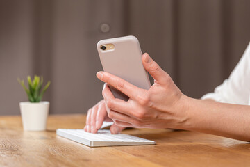hands of women who use laptop keyboard and mobile phone. concept of email delivery and use of online technology
