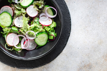 vegetable salad radish, cucumber, mix leaves meal snack summer menu diet vegan or vegetarian food copy space food background rustic top view
