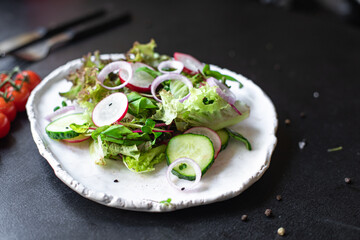 vegetable salad radish, cucumber, mix leaves meal snack summer menu diet vegan or vegetarian food copy space food background rustic top view