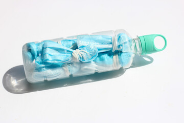 Prevent coronavirus, Used face masks in plastic bottle before littering