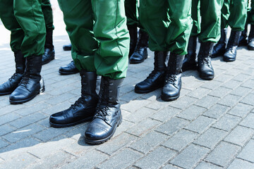 Soldiers in leather boots and green uniforms. Formation of the army before performing a combat...