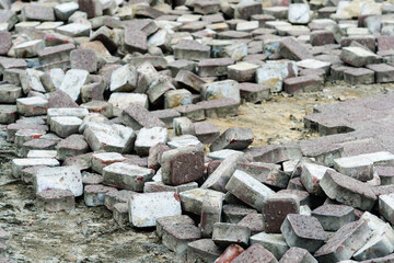Dismantling of paving stones on a city street. Construction of new pedestrian roads and landscaping. Selective focus