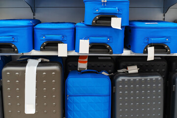 Travel suitcases of various shapes and colors are displayed in the shop window. Medium plan