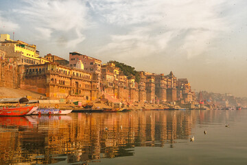Feb 02, 2021, India, Varanasi Ganges river ghat with ancient city architecture as viewed from a boat on the river at sunset.