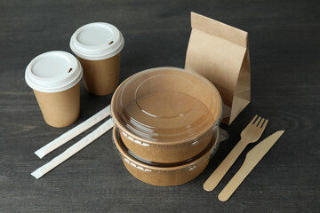 Delivery containers for takeaway food on dark wooden table