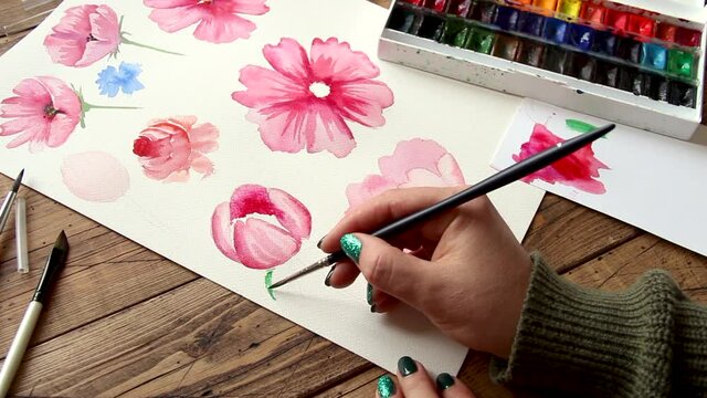 Painting pink flower with watercolors close up