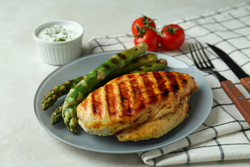 Concept of tasty eating with grilled chicken meat on white textured table