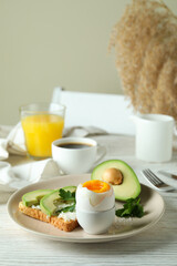 Concept of tasty breakfast with boiled egg, space for text