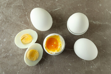 Tasty boiled eggs on gray textured table