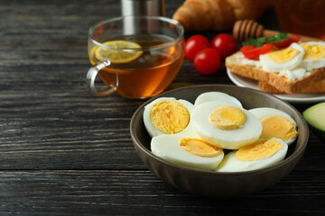 Concept of tasty breakfast with boiled eggs on wooden table