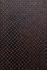 赤黒く輝くチェッカープレートの鋼板