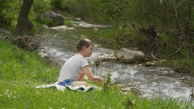 Little boy exploring a stream