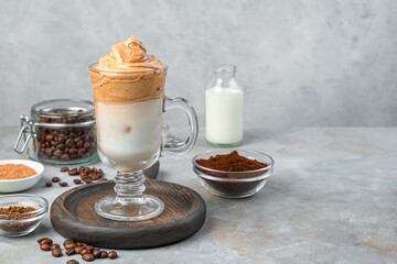 Dalgona iced coffee on a gray vintage background. Coffee foam with milk and ice.