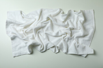 Clean crumpled towel on white background, top view