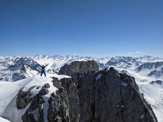 Ski mountaineering. Men looks at the summit and enjoys the fantastic view of the snowy mountains. Ski tour Switzerland
