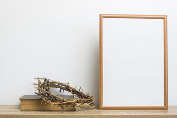 A thorn crown with mock up photo frame on table. 