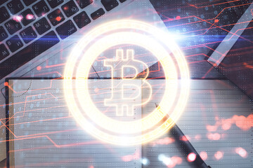 Blockchain theme hologram drawings over computer on the desktop background. Top view. Double...