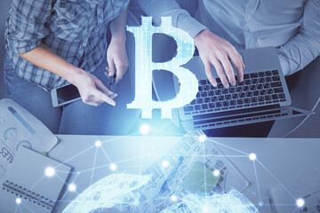 Double exposure of man and woman working together and crypto theme hologram drawing. Computer...