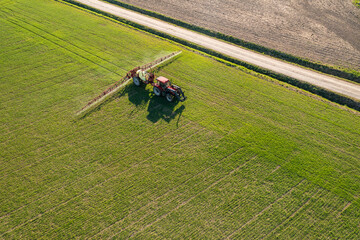 Farmer spraying chemical treatment on an agricultural field in Finland.