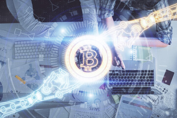 Double exposure of man and woman working together and crypto theme hologram drawing. Computer background. Blockchain concept. Top View.