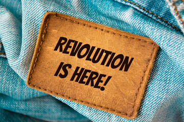 Text sign showing Revolution is Here 