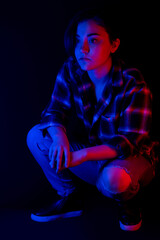 Fototapeta na wymiar Portrait of teen with blue and red light