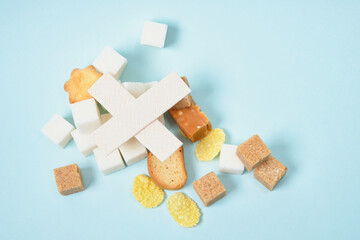 sweets and sugar on light blue and yellow background