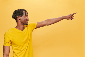 Handsome Afro Man Posing Over Yellow Background wearing yellow t-shirt