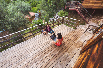 A woman conducts a lesson on the veranda at home, home education, distance education