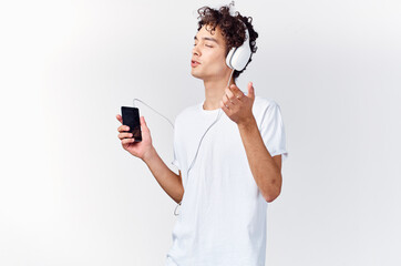 Cheerful man in headphones listens to music technology dancing