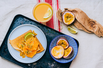 Crepes Or Thin Pancakes With Delicious passion fruit and lime.