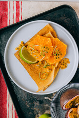 Crepes Or Thin Pancakes With Delicious passion fruit and lime.