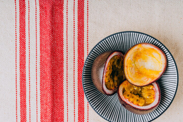 Sliced passion fruit in a blue plate in asian style