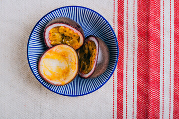 Sliced passion fruit in a blue plate in asian style