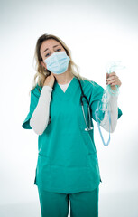 Exhausted Doctor holding medical ventilator after shift in the coronavirus intensive care unit