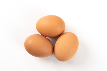 Raw brown chicken eggs on white background