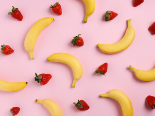 Summer pattern made with bananas and strawberries on pastel pink background. Minimal fruit and...