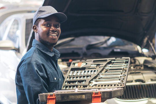 African maintenance male holding a set of car repair tools in box