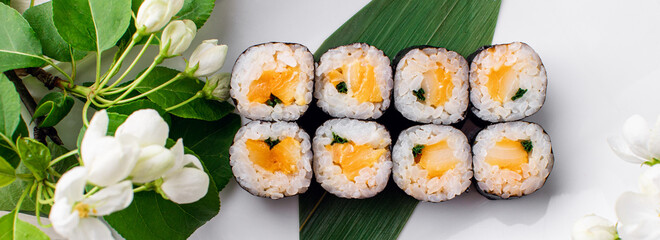 Sushi rolls served on a wooden plate in a restaurant